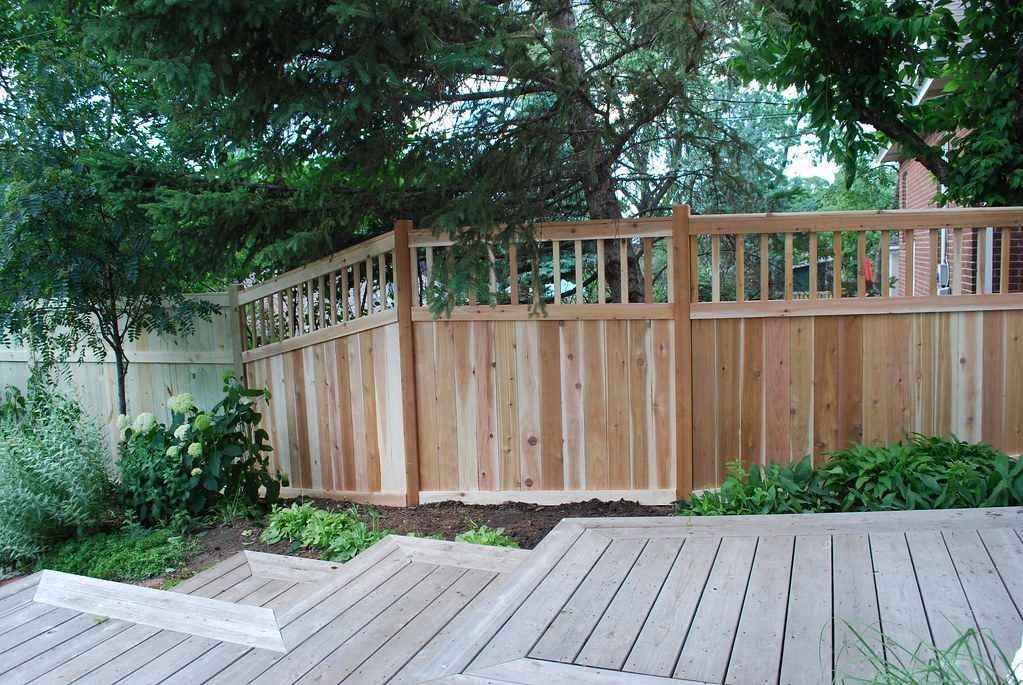 Wood privacy fence along a residential side yard, shown as a style example of privacy fencing